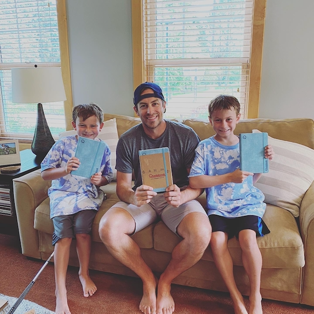 Family holding their Quotebooks