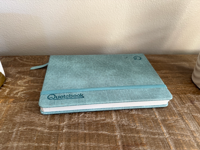 Quotebook on a shelf alongside keepsakes